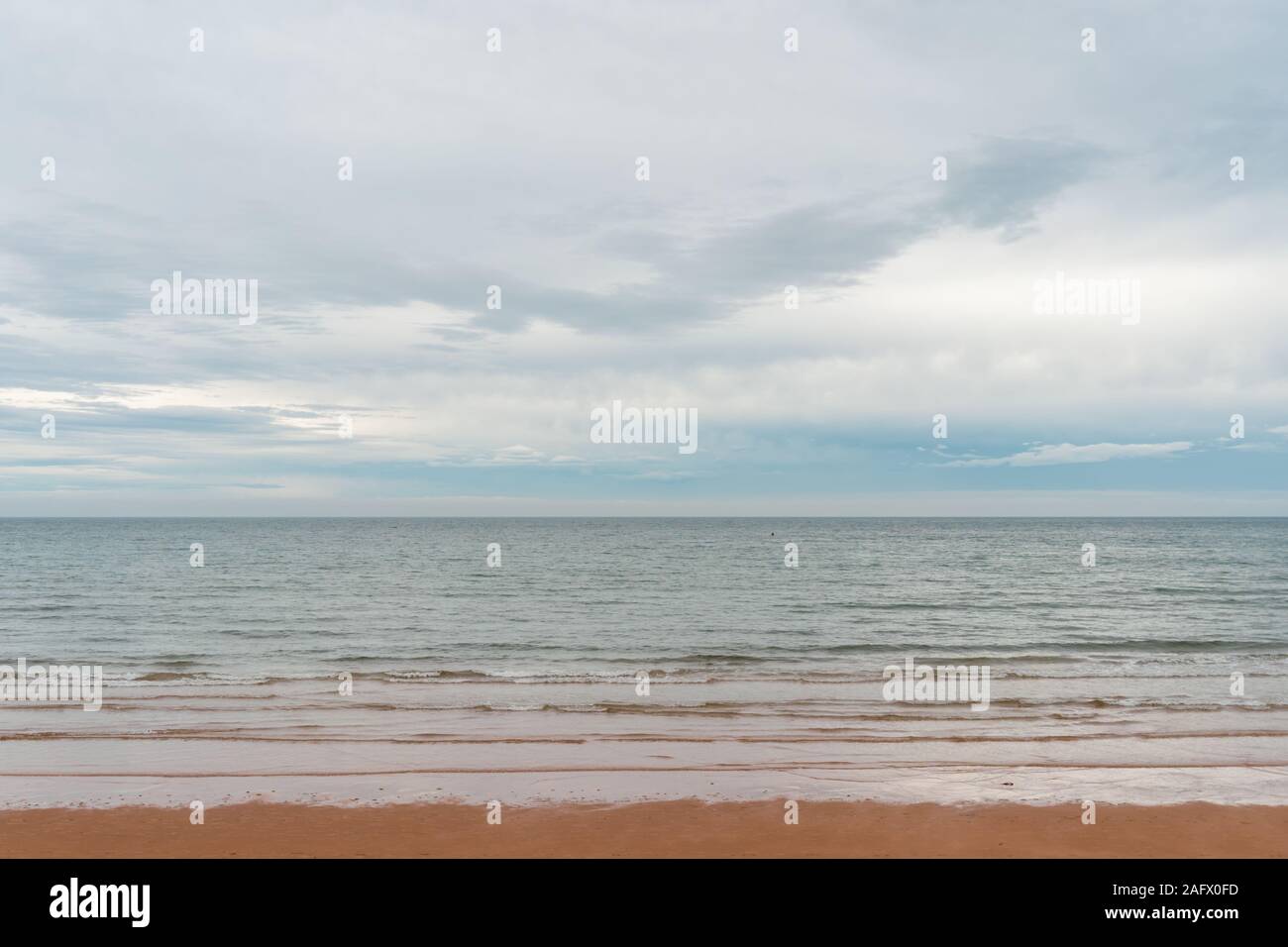 Landscape of a sea from the beach under a cloudy sky during daytime ...