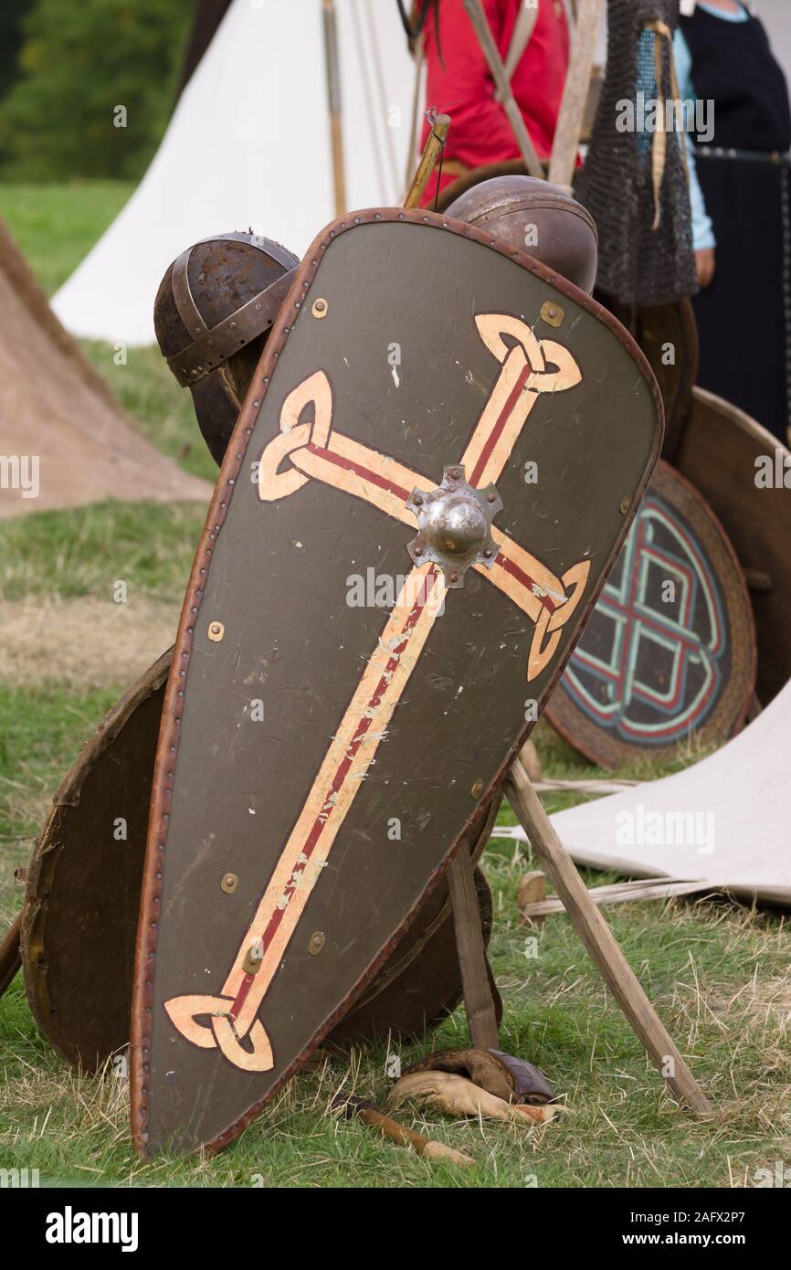 Medieval shields and helmets stacked at battle re-enactment camp Stock Photo