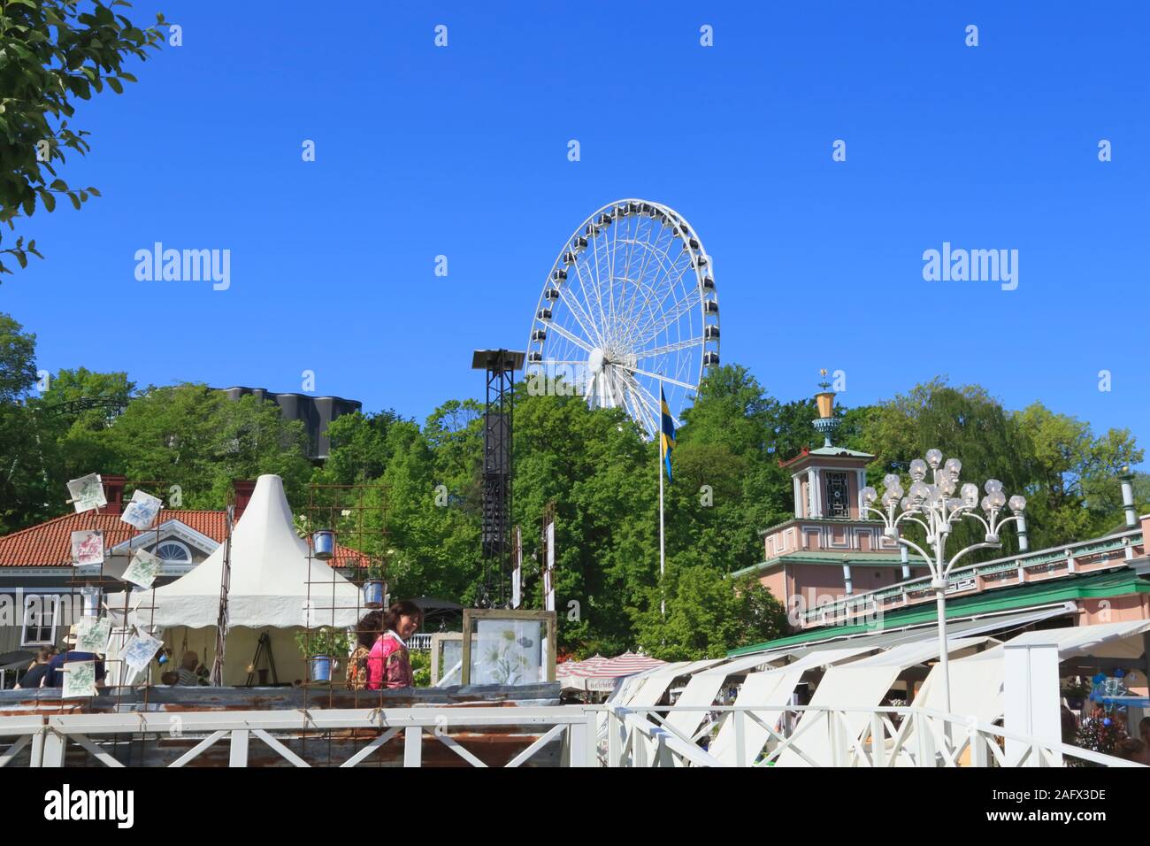 Part of the big wheel visible above the trees in Liseberg amusement park in Gothenburg city, Sweden. Stock Photo