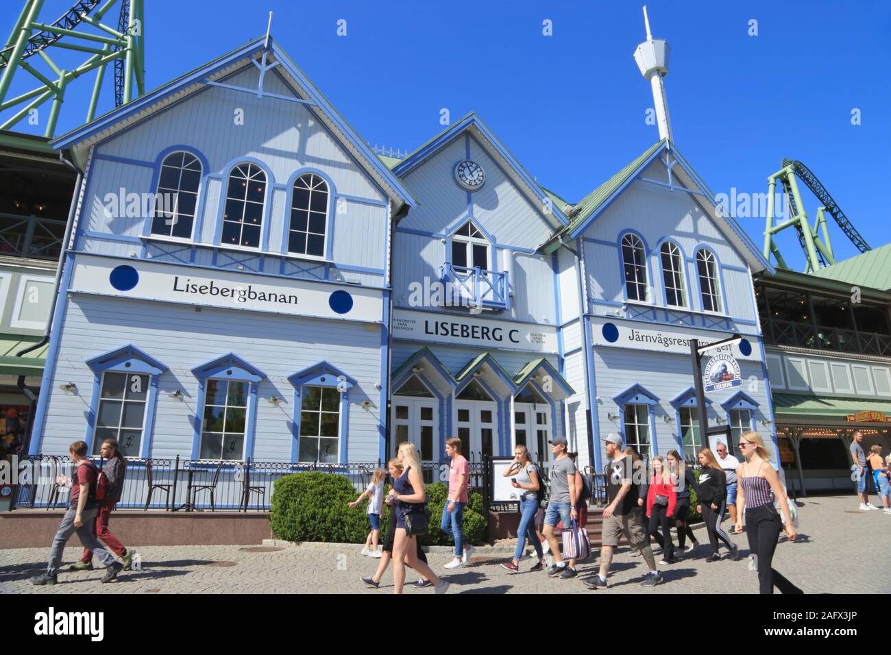 People walk past the station building and entrance to the roller coaster called Lisebergbanan in Liseberg amusement park in Gothenburg city, Sweden. Stock Photo