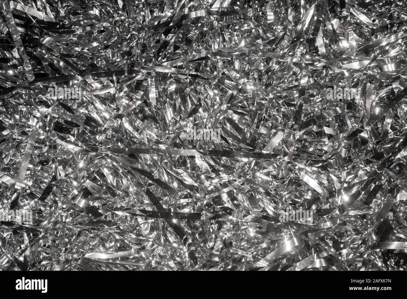 Abstract festive background of a jumble of silver tinsel Stock Photo