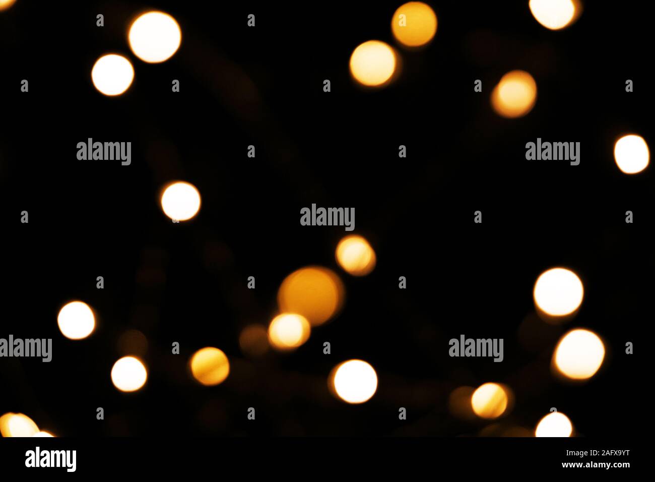 Abstract background with golden glitter light bokeh isolated on black ...
