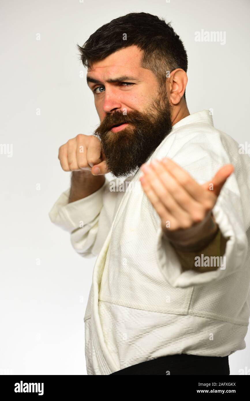 Judo master practices attack and provokes fight. Karate man with flirty