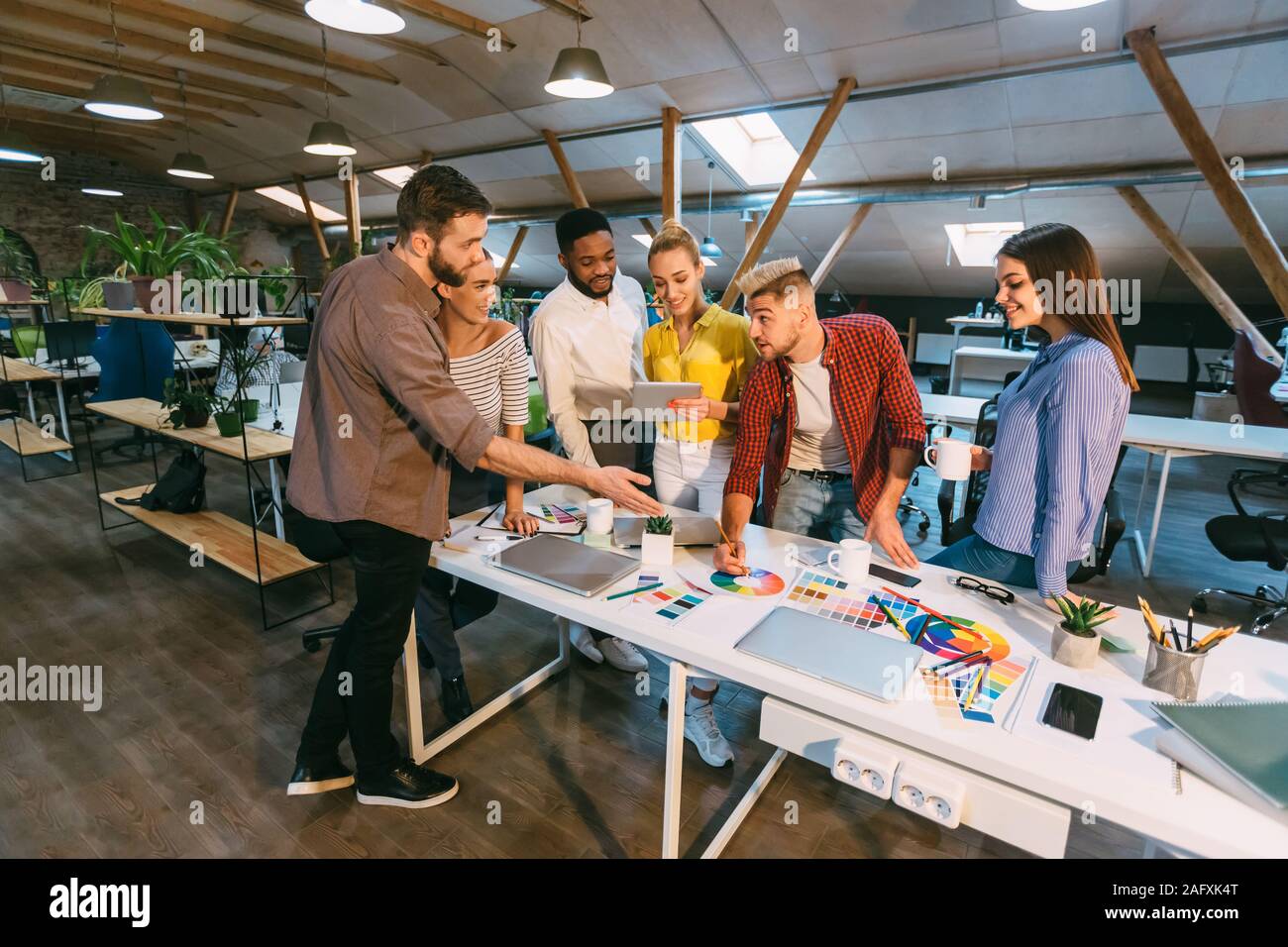 Creative team discussing new product plan, choosing main color Stock Photo