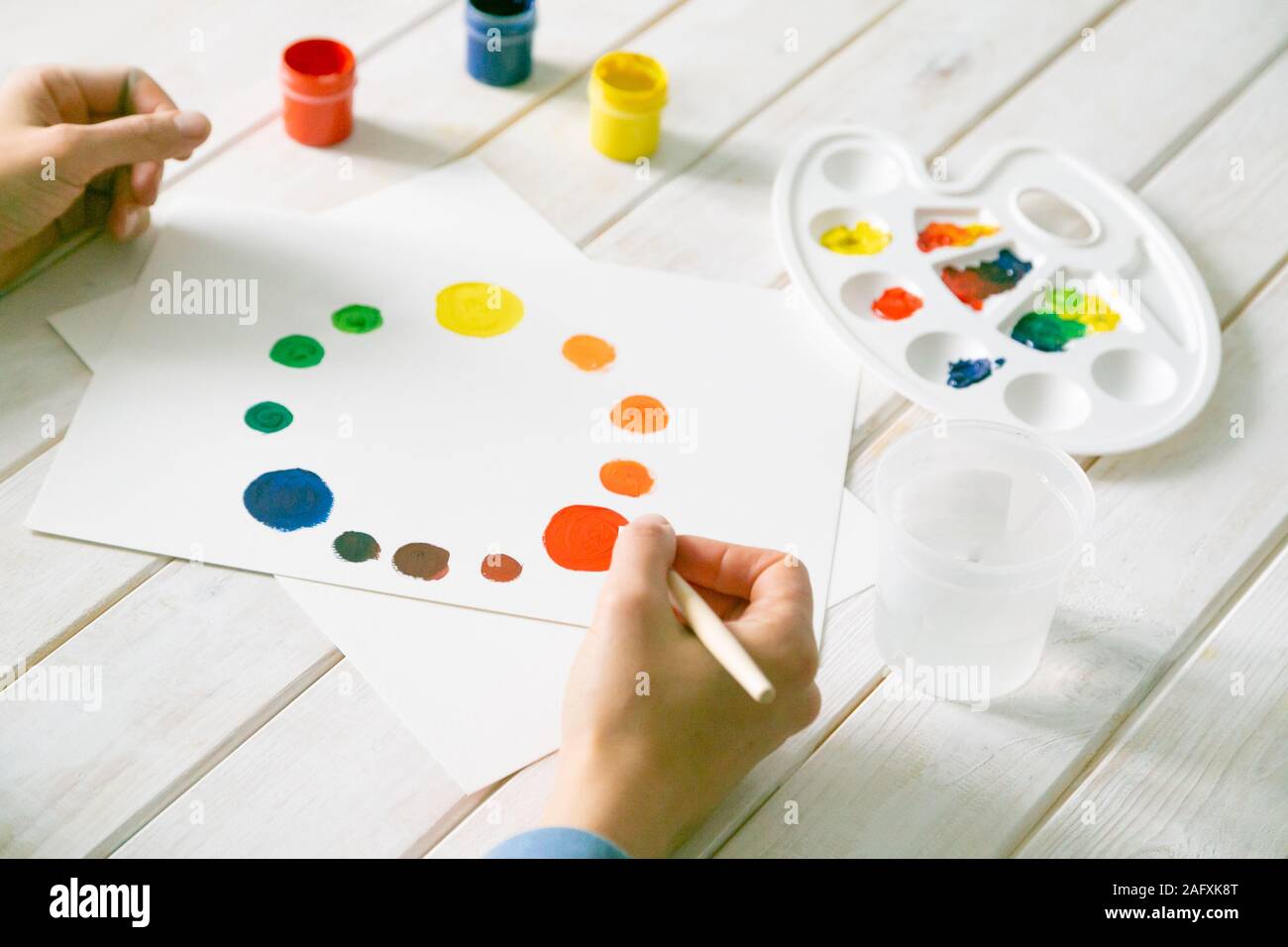 Art concept - colour wheel, gouache paints, brush and palette Stock Photo