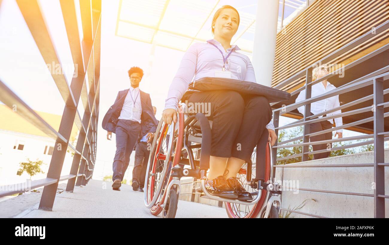 Woman with a wheelchair on a barrierfree ramp to access the wheelchair