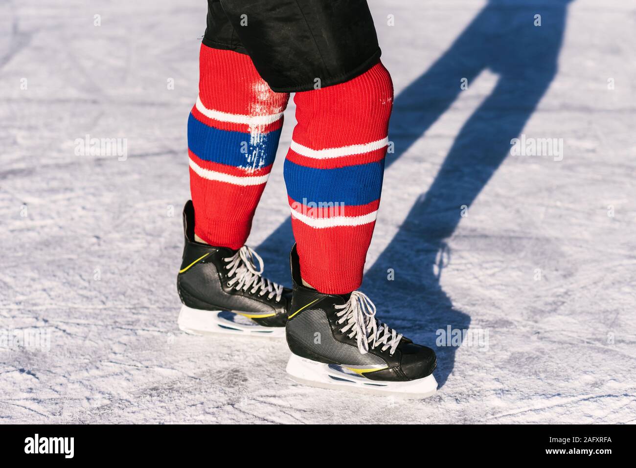 hockey players legs closeup during a game on ice Stock Photo Alamy