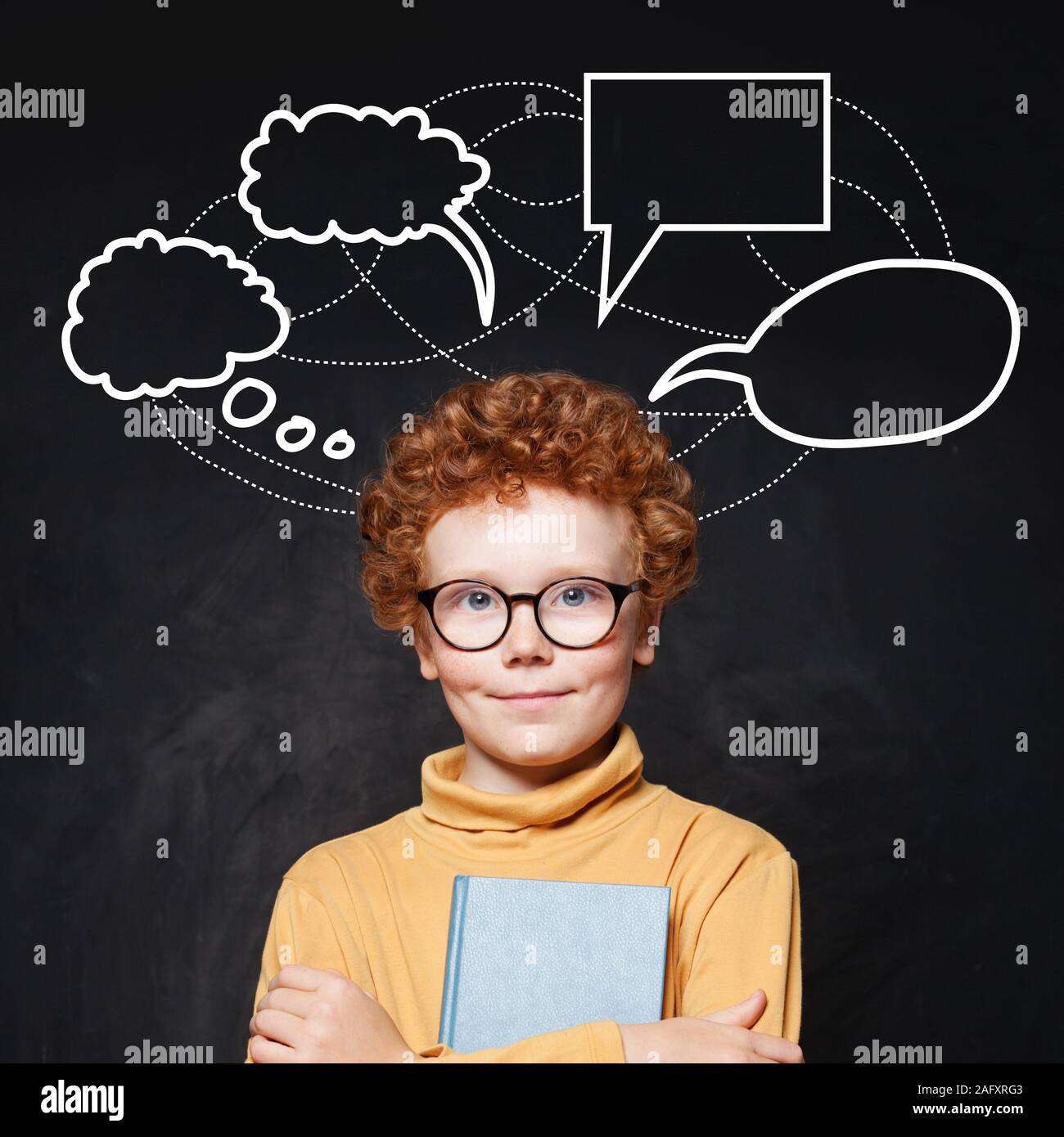 Redhead boy in glasses and empty speech clouds bubbles Stock Photo