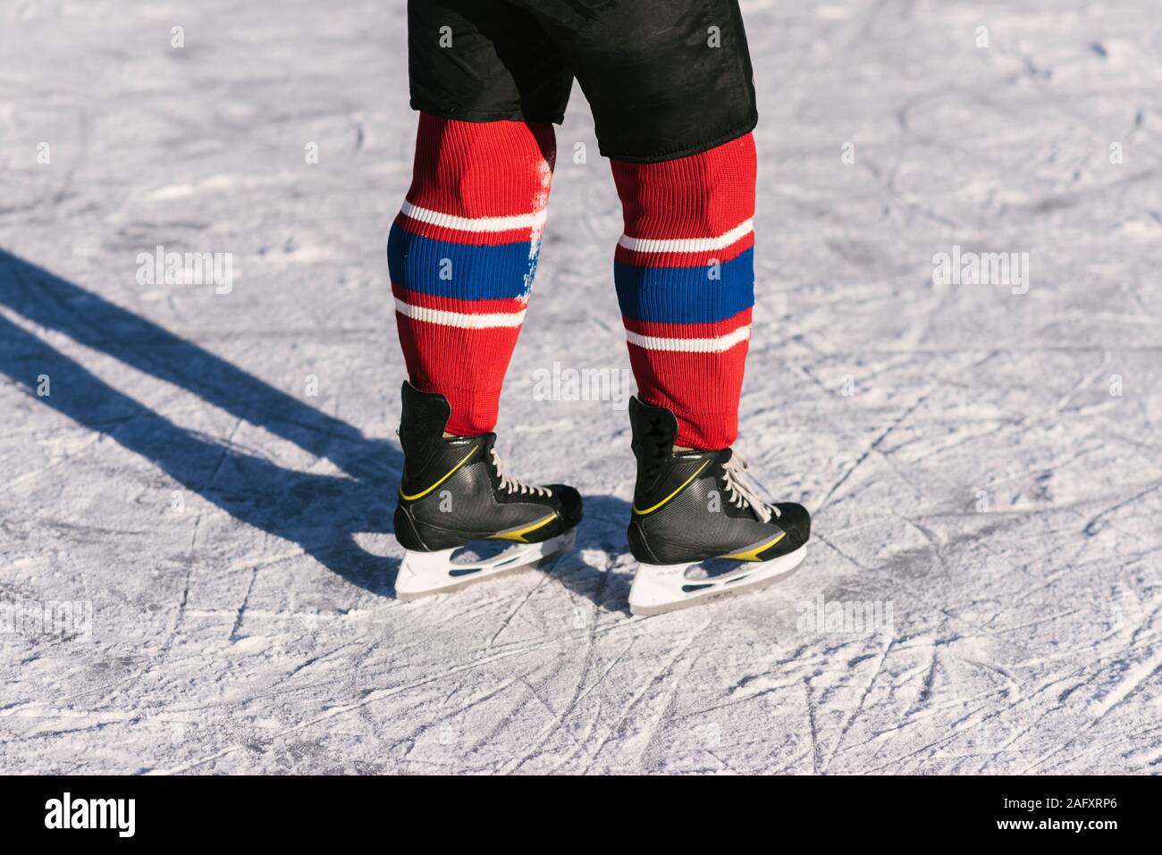 hockey players legs closeup during a game on ice Stock Photo Alamy