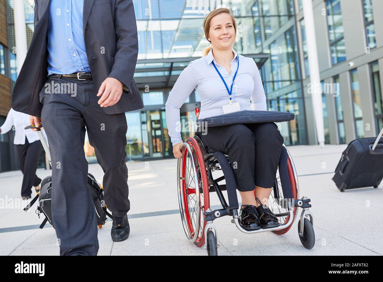 Disabled businesswoman in wheelchair on departure after meeting or congress  Stock Photo - Alamy