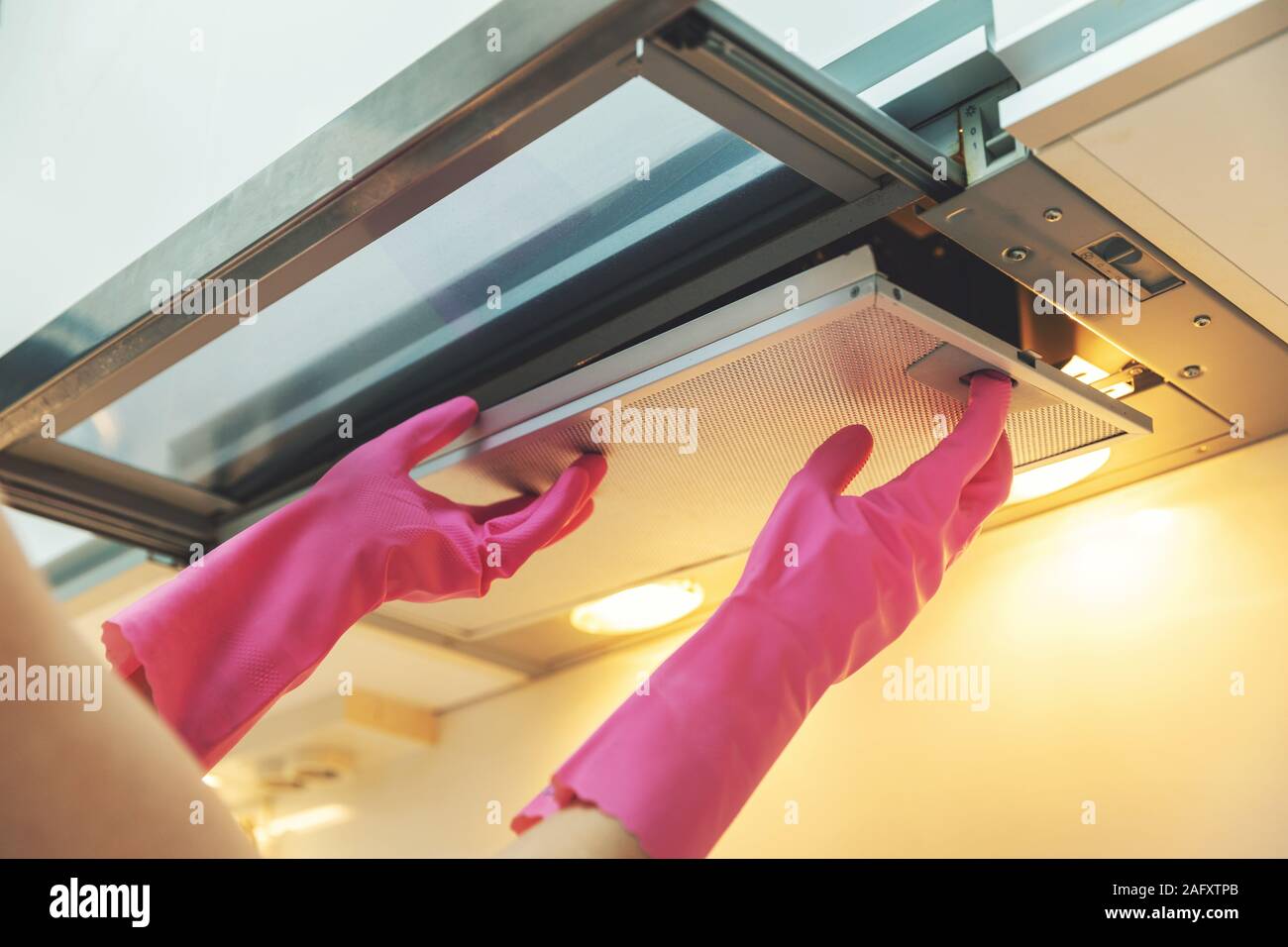 removing dirty cooker hood filter for cleaning Stock Photo