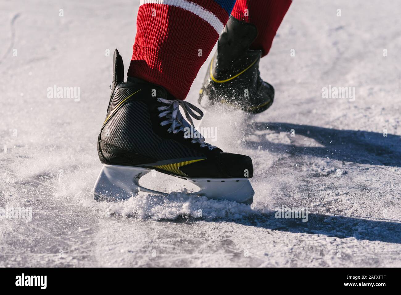 hockey players legs closeup during a game on ice Stock Photo Alamy