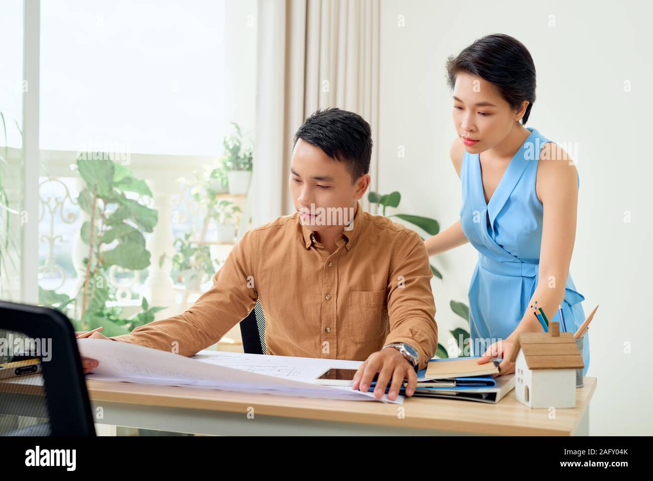 Cheerful two architects are discussing new project Stock Photo