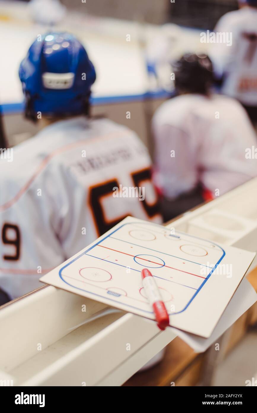 hockey players sit on the bench in the stadium Stock Photo