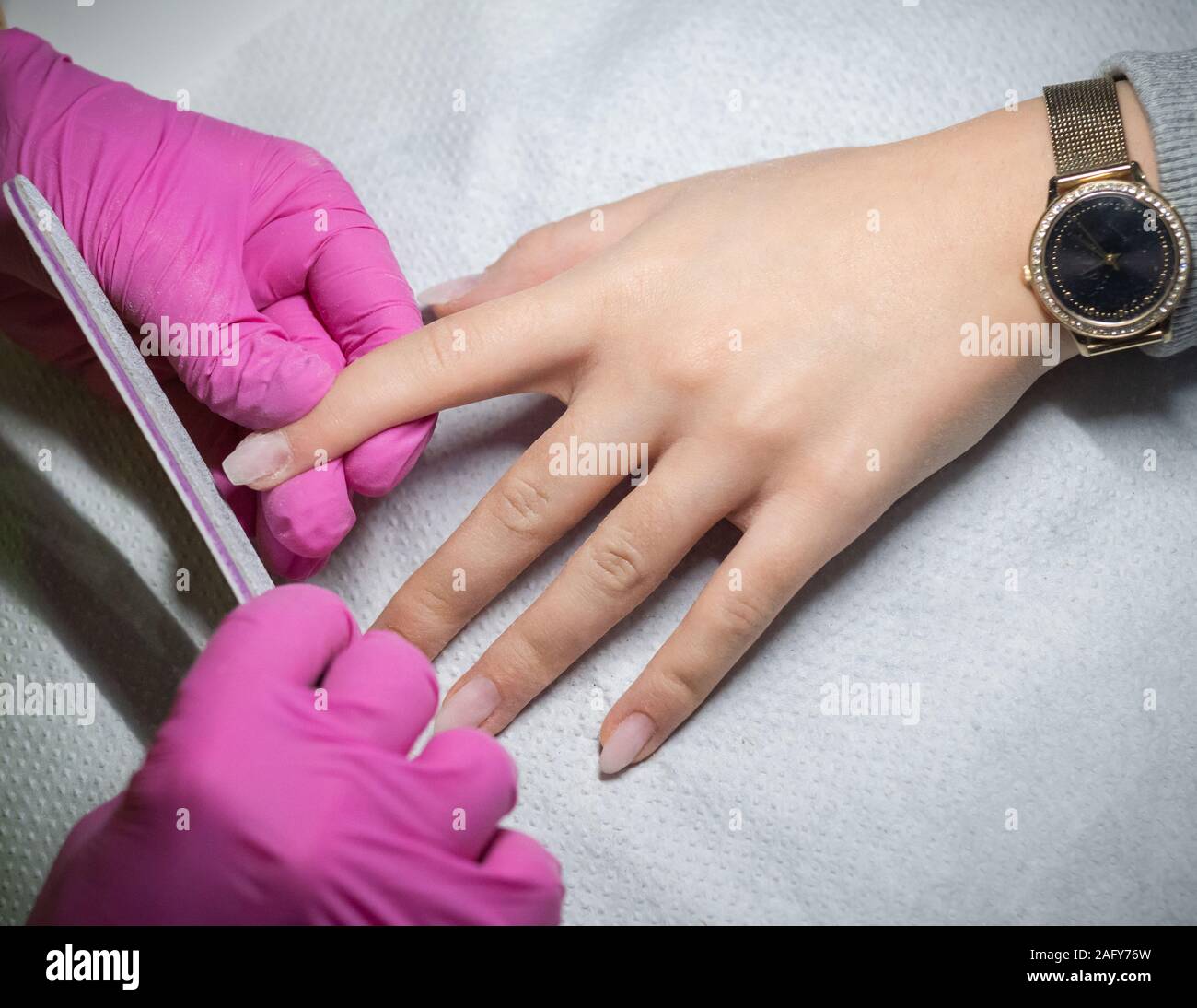 Woman getting nails filing by a professional manicurist. Stock Photo