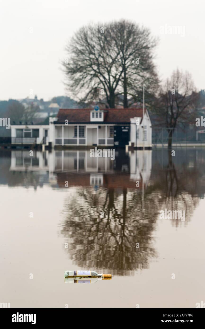 Worcester, Worcestershire, UK. 17th Dec, 2019. An empty bottle of wine floats in the flooded Kings School sports ground, Worcester, as flood water from the River Teme inundates the area. Credit: Peter Lopeman/Alamy Live News Stock Photo