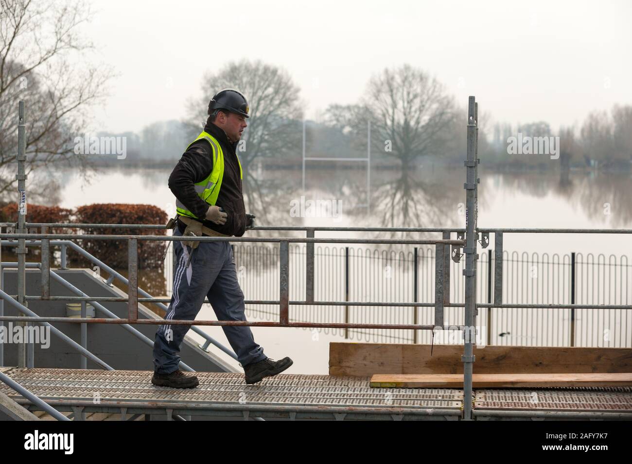 Worcester, Worcestershire, UK. 17th Dec, 2019. Worcester County cricket ground floods with water from the River Teme and is under several feet of water for the fifth time in 2019. Workmen put temporary walk boards to ease access to the ground's buildings. Credit: Peter Lopeman/Alamy Live News Stock Photo