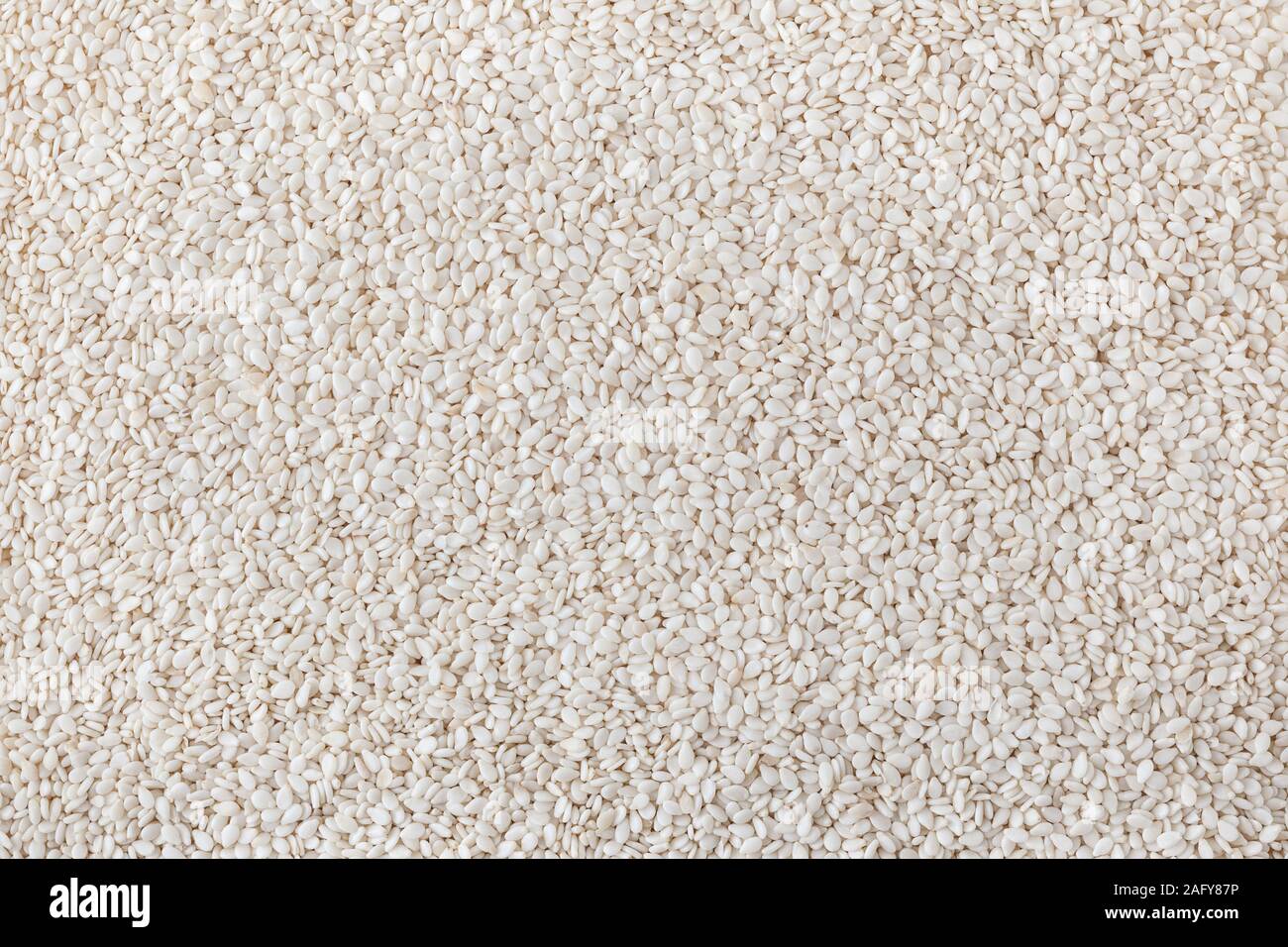 Dry sesame seeds background Stock Photo - Alamy