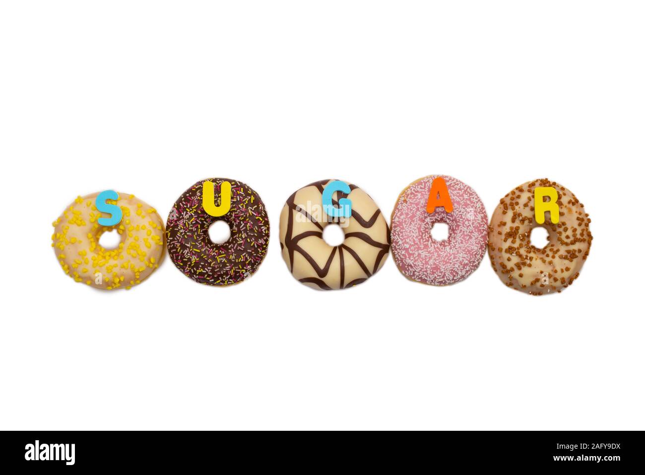 various colored delicious donuts on white background with the word sugar, space for text Stock Photo