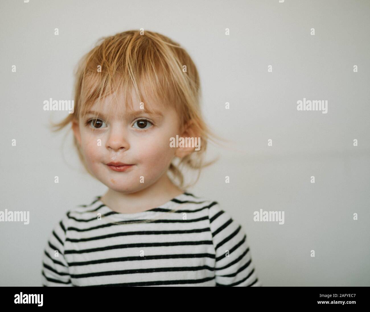 portrait of toddler against white background Stock Photo