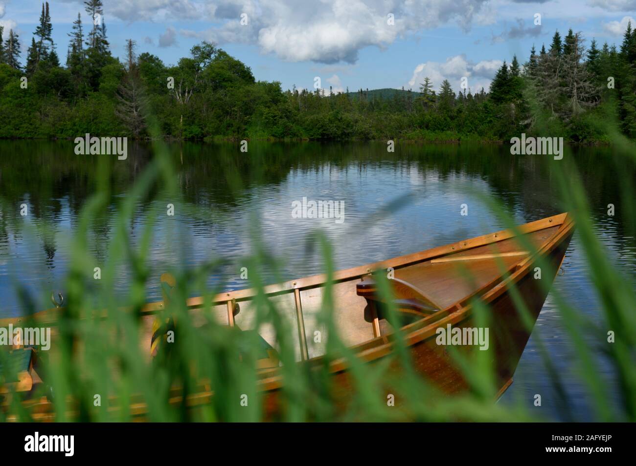 A wooden drift boat sitting in the Androscoggin River in New Hampshire Stock Photo