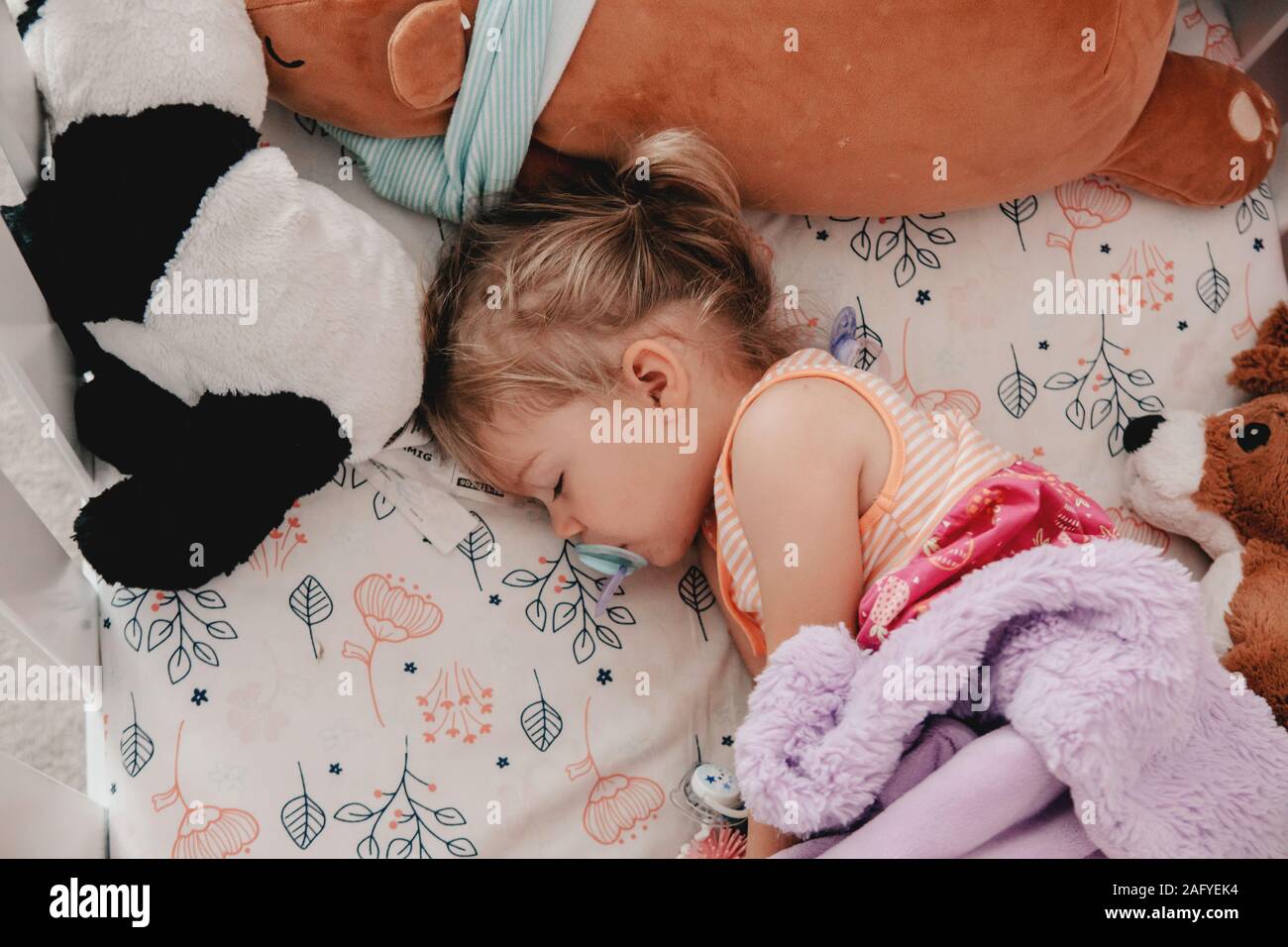 sleeping toddler with her blue binky Stock Photo Alamy