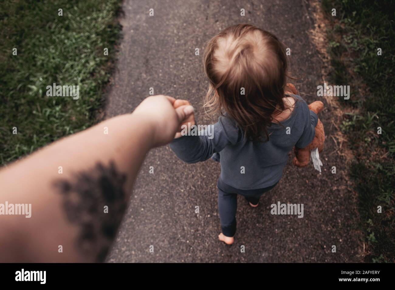 holding hands and walking down the street Stock Photo