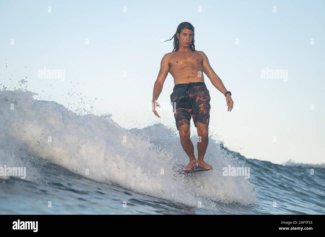 Surfing the sunrise in Costa Rica Stock Photo