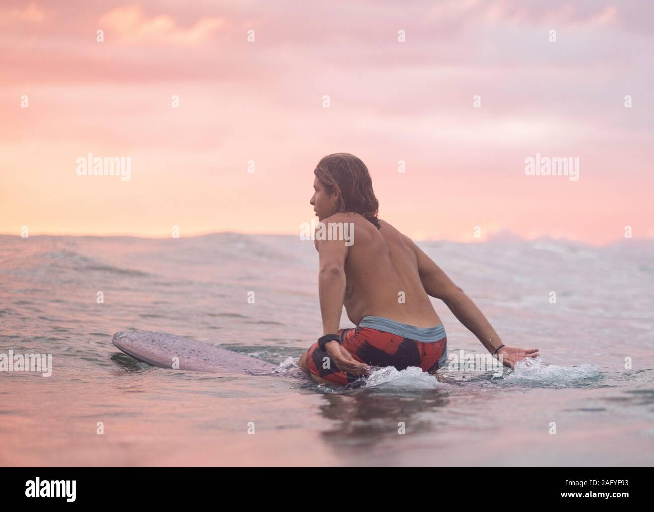 Surfing the sunrise in Costa Rica Stock Photo