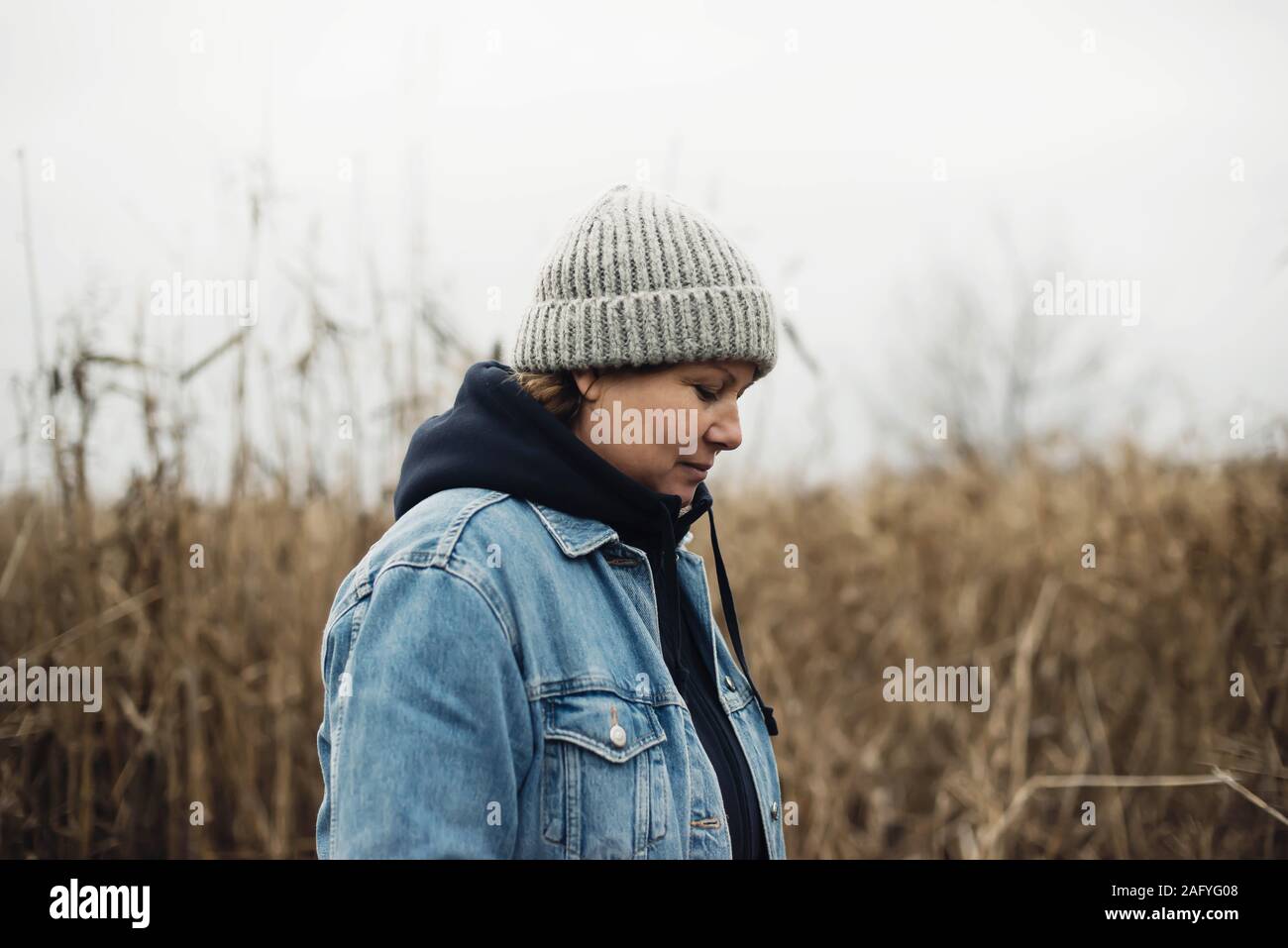 Portrait of a 40 years old woman in a hat outdoors Stock Photo