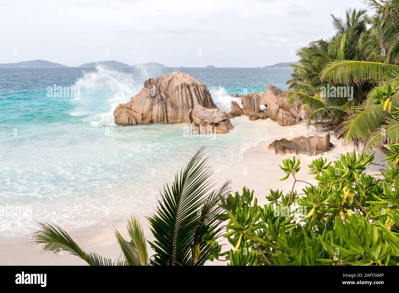 Beach with blue water and blue sky and white sand and some rocks Stock ...