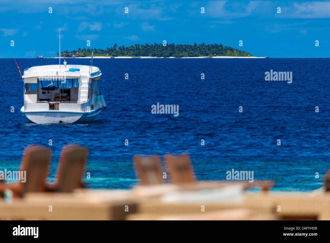 View from the beach bar to the ocean with a boat and an another island Stock Photo