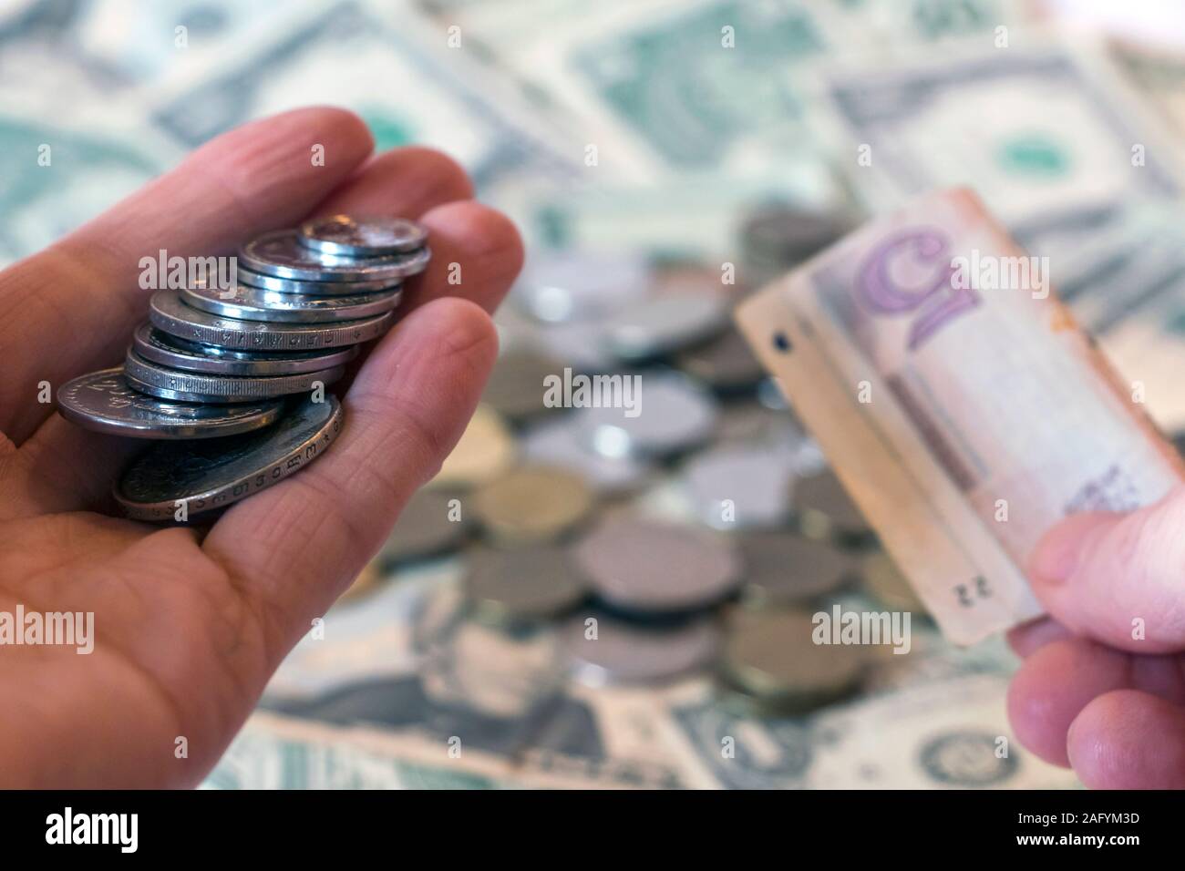Hand holding georgian lari coins and banknotes against usd american dollar background with russian ruble rub coins. International currency and economy Stock Photo