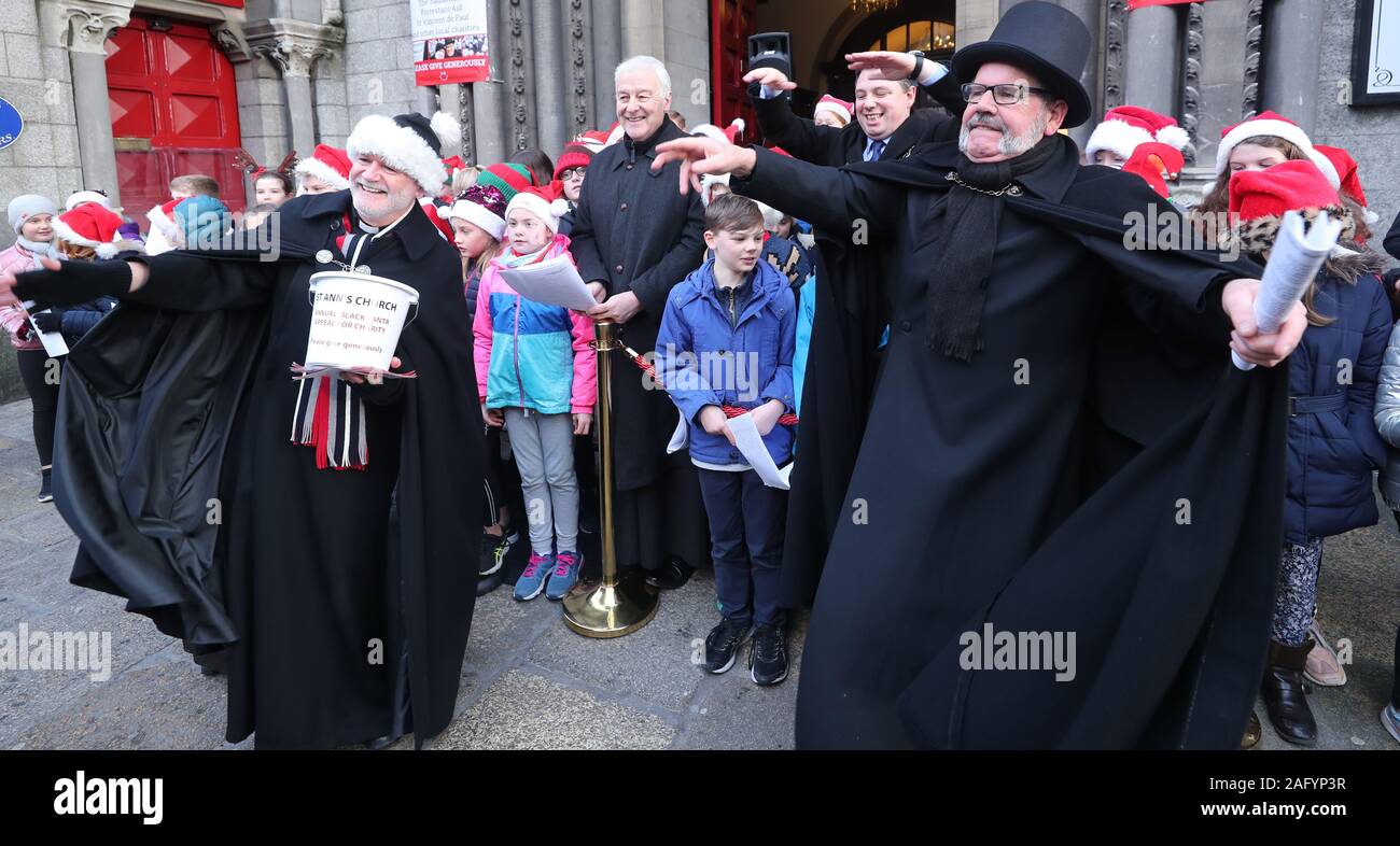 Canon David Gillespie (left) is joined by Anglican Archbishop of Dublin, the Most Revd Dr Michael Jackson (centre left)) and Lord Mayor of Dublin, Paul McAuliffe ( centre right) , outside St. Ann's Church, Dublin, as they begin the Black Santa sit-out to raise money for charities working with homeless people. Stock Photo