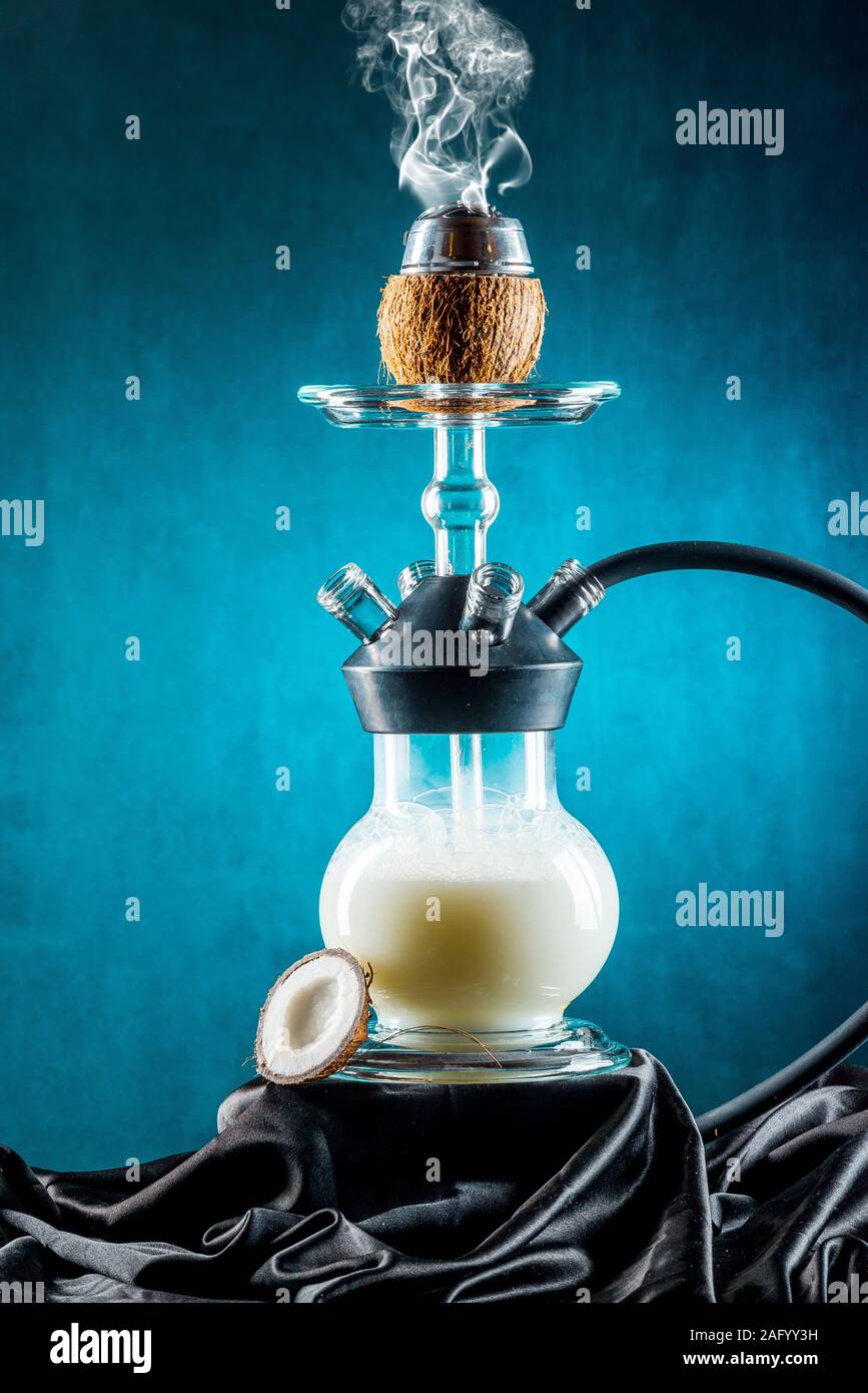 Milk hookah with fruits against a dark background with smoke Stock Photo