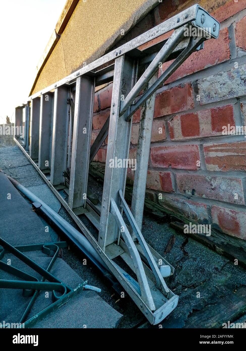A set of common household ladders, stored away on top of a small