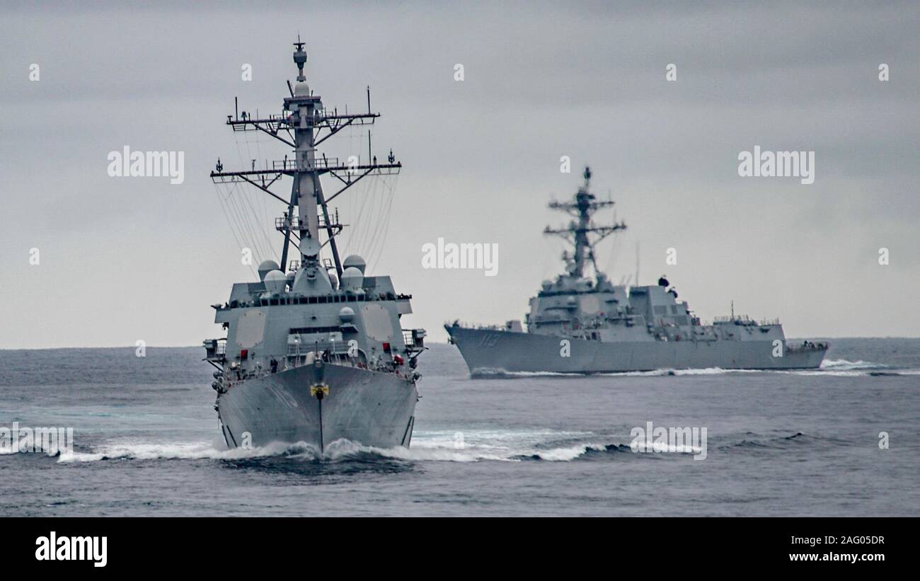 A U.S. Navy Arleigh Burke-class guided-missile destroyers USS Rafael Peralta and USS John Finn, right, during routine training operations December 7, 2019 in the Pacific Ocean. Stock Photo