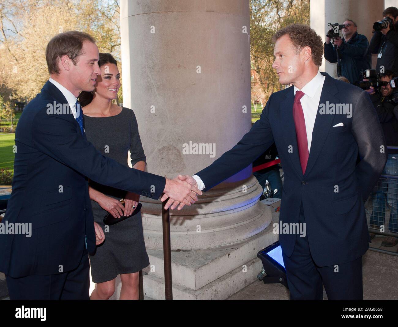 Viscount Rothermere chairman of the IWM Foundation welcoming The Duke and Duchess of Cambridge to a fund raising event at the Imperial War museum in London in 2012. Stock Photo