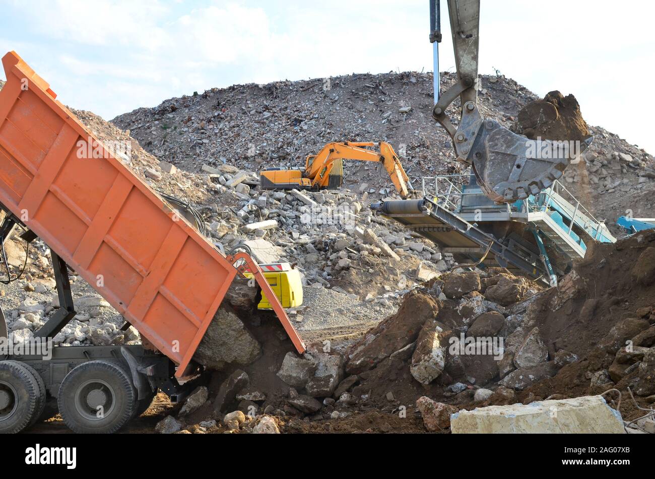Dump truck unloading of broken concrete slabs demolition waste on 