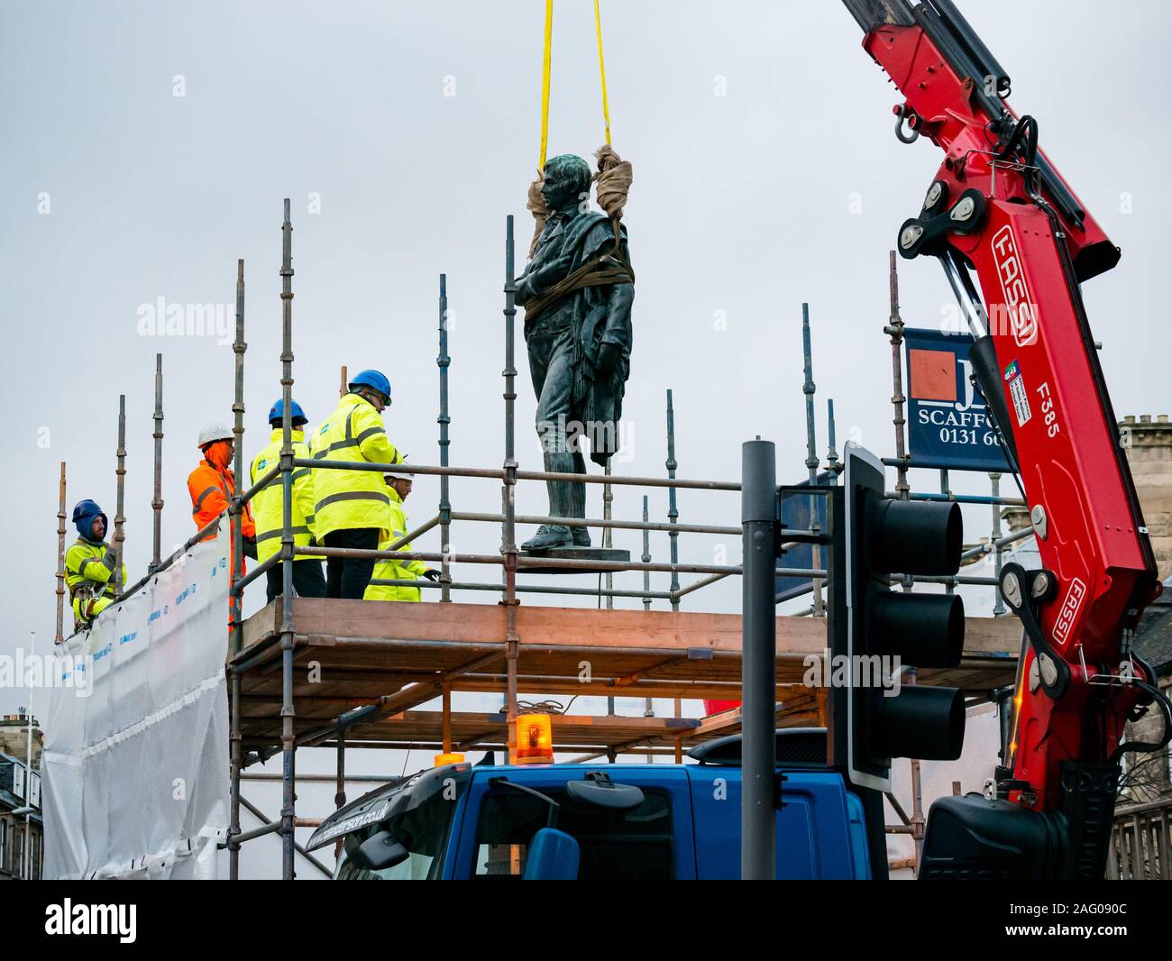 Leith, Edinburgh, Scotland, UK. Robert Burns statue by David Watson Stevenson in Bernard Street is removed by crane  for the Trams to Newhaven construction work. It will be restored and stored until it can be replaced at a nearby location once the work is complete in 2023 Stock Photo