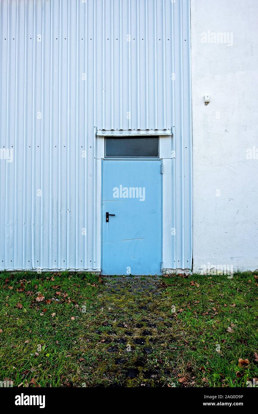 light blue steel door to a warehouse in rural areas Stock Photo - Alamy