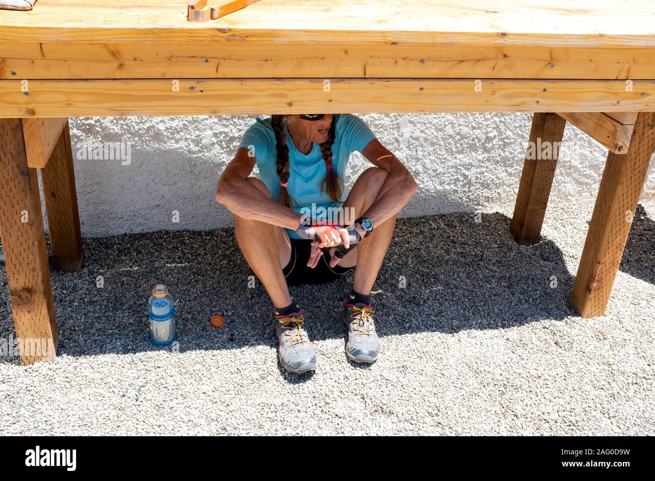 CO00122-00...COLORADO - Vicky Spring finds some shade during a break in the town of Hartsel along the Great Divide Mountain Bike Route. MR# S1 Stock Photo
