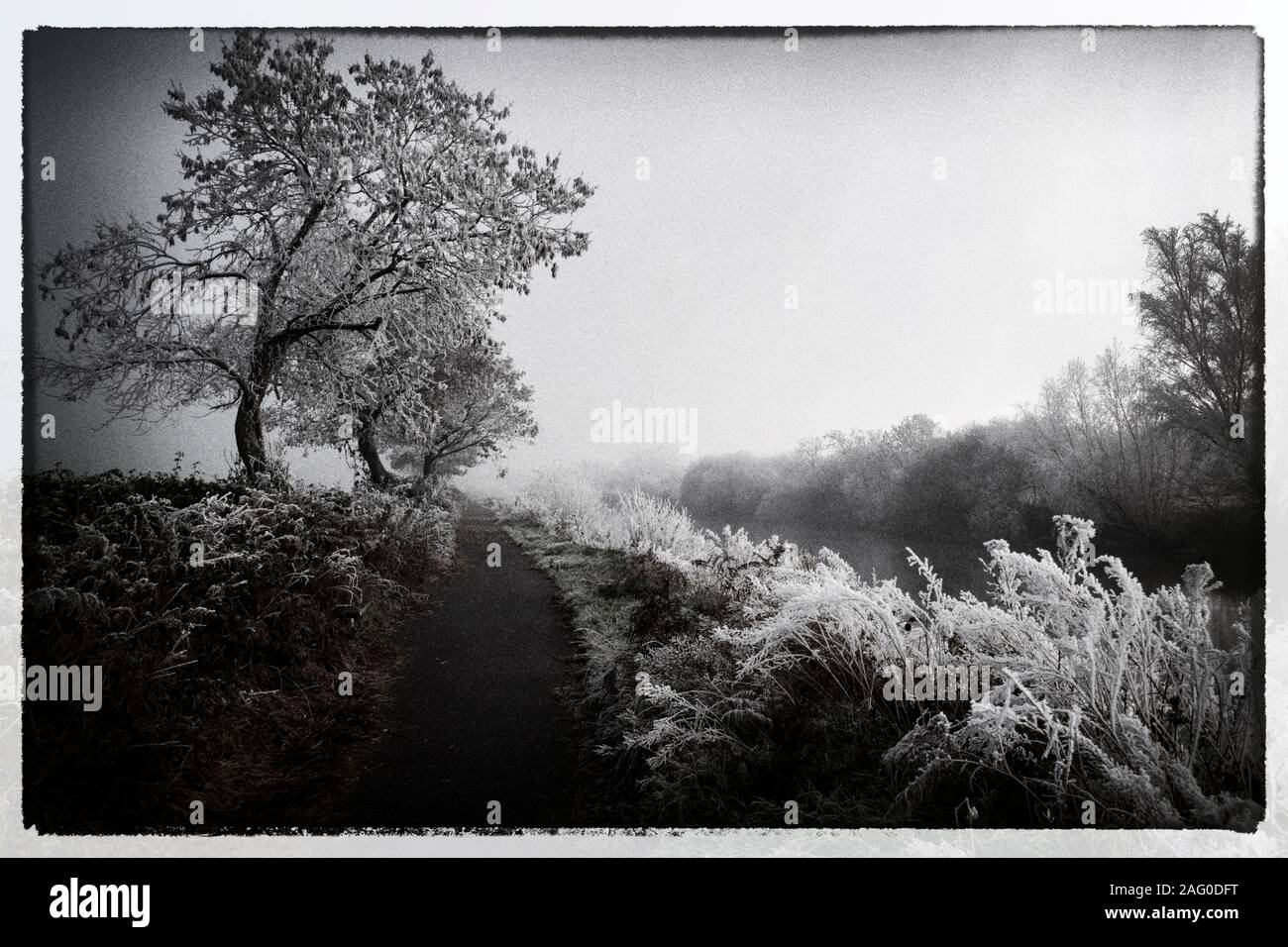 Illustration of a river landscape in winter in black and white colours ...