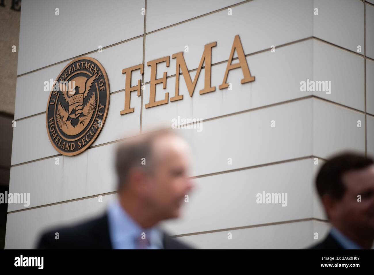 People walk in front of the Federal Emergency Management Agency logo at the FEMA headquarters in Washington, D.C., as seen on September 9, 2019. (Graeme Sloan/Sipa USA) Stock Photo