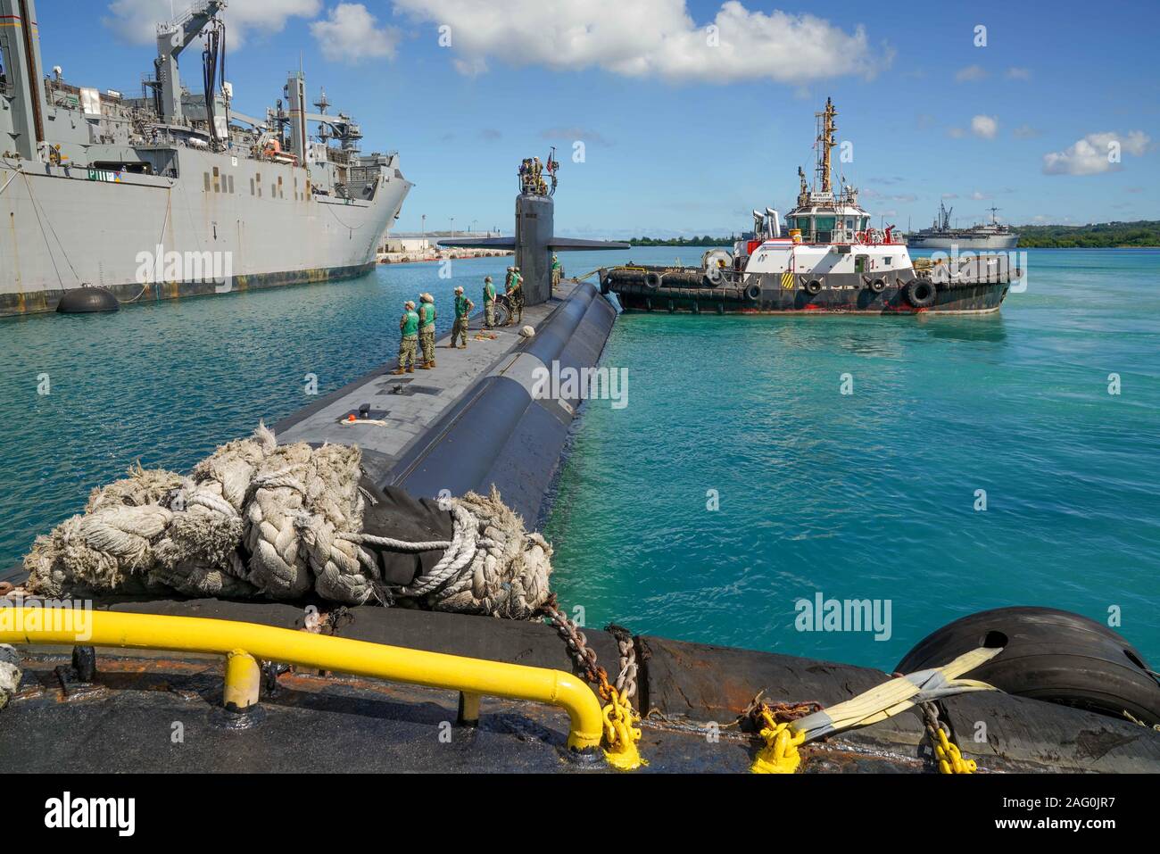 The U.S. Navy Los Angeles-class fast attack submarine USS Key West prepare to moor to the Lewis and Clark-class dry cargo and ammunition ship USNS Richard E. Byrd at Naval Base Guam December 10, 2019 in Santa Rita, Guam. Naval Base Guam is home to four Los Angeles-class attack submarines in the 7th Fleet and supports allied operations in Asia. Stock Photo