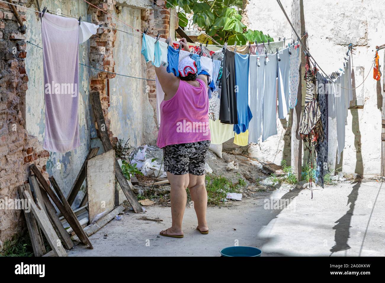 A lady hanging out her washing in Central Havana, Cuba. Stock Photo