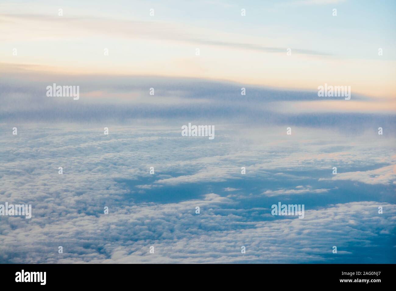 flying above the clouds at sunset landscape from an airplane Stock ...