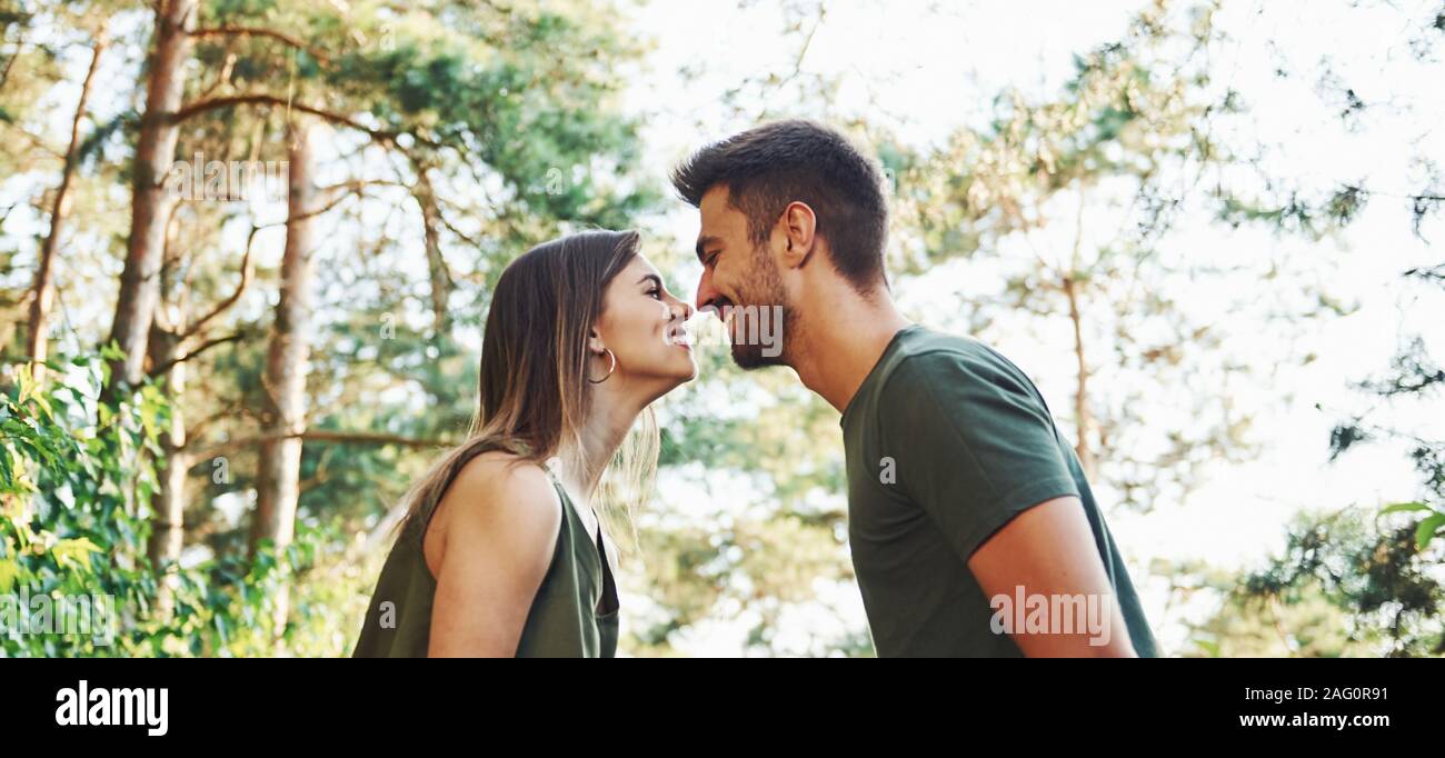 Beautiful young couple have a good time in the forest at daytime Stock Phot...