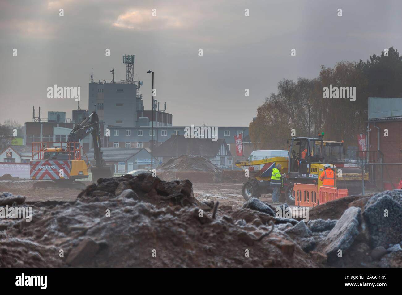 UK building site on a cold, misty, frosty, winter morning in December. British building site with people working. Stock Photo