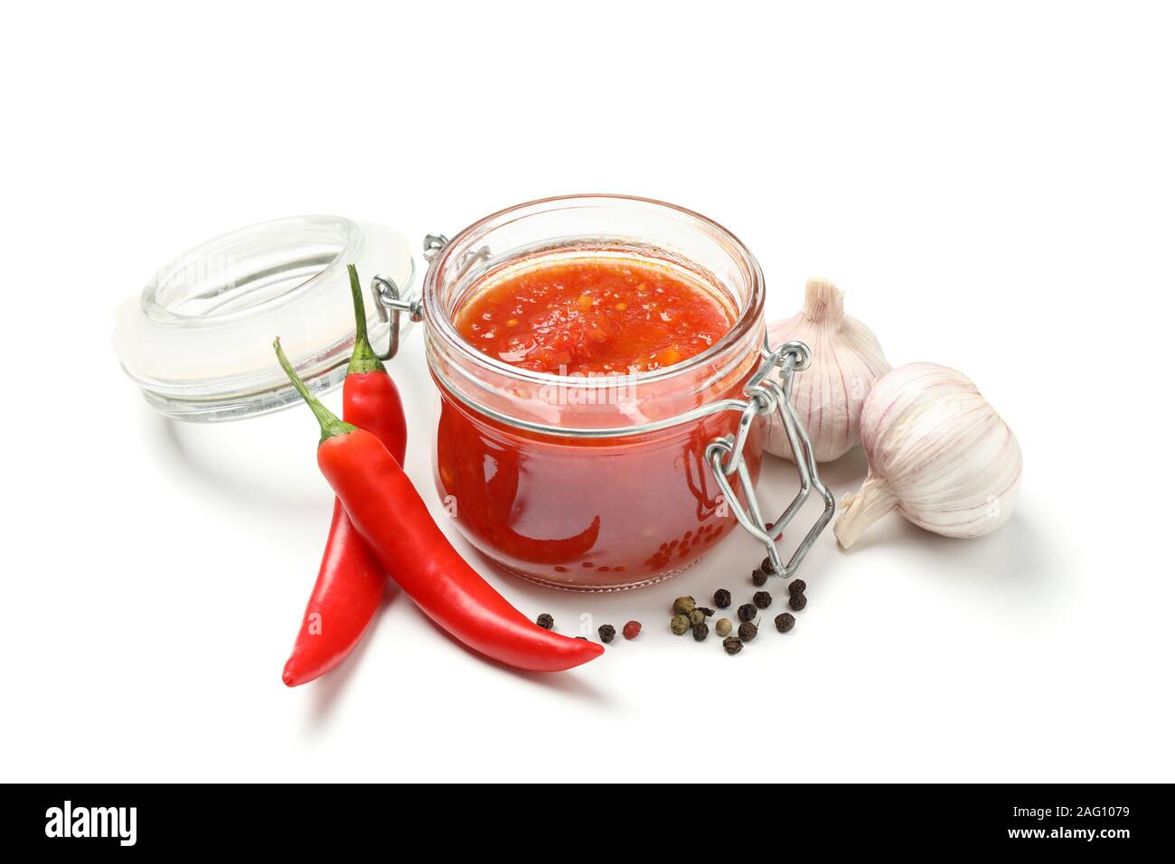 Tasty chili sauce in glass jar and ingredients isolated on white ...